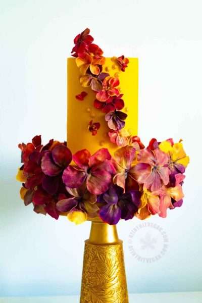 Vibrant yellow two tier flower dance cake